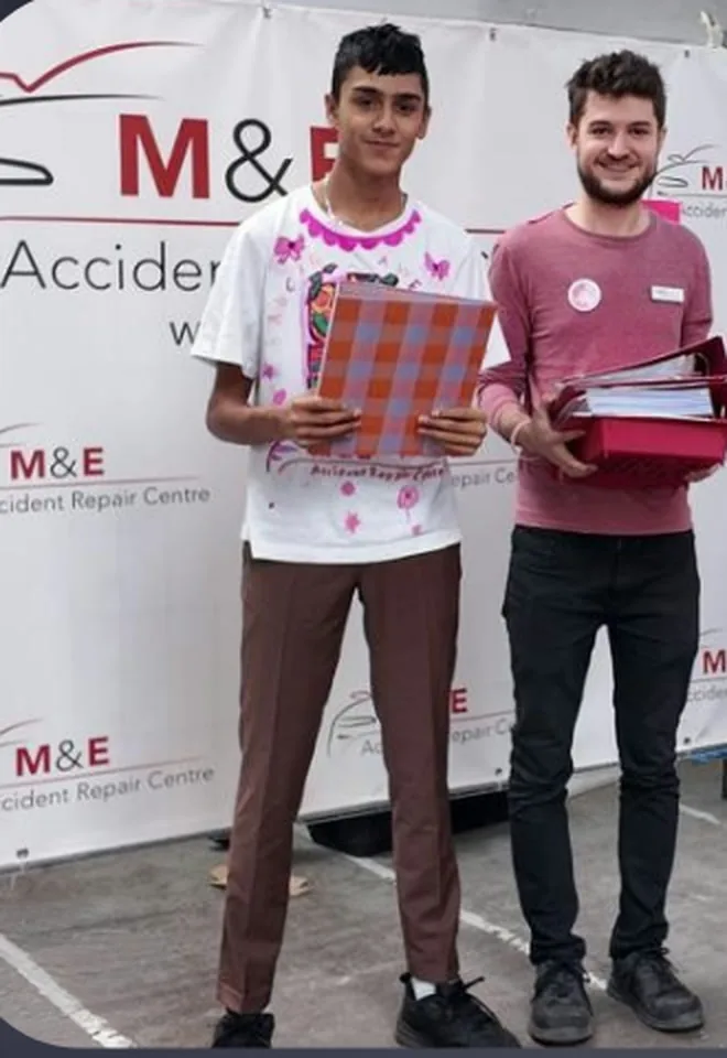 Oliver Rorzkowski with a colleague in front of M&E Accident Repair Centre branding
